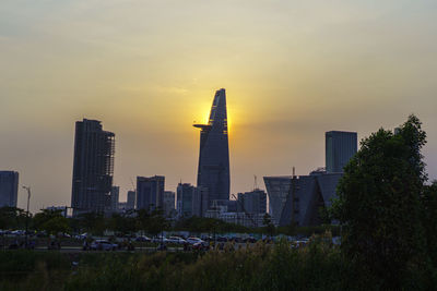 Buildings in city against sky during sunset