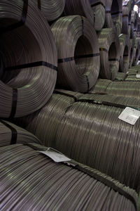 Full frame shot of metallic rolled up wires at steel plant