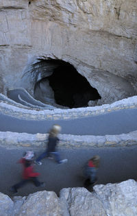 High angle view of people on rock