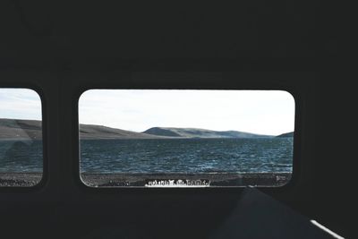 Scenic view of sea seen through airplane window