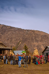 People at town square against mountains