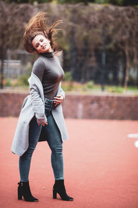 Portrait of smiling young woman standing outdoors