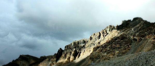 Scenic view of mountains against cloudy sky