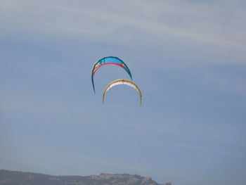 Low angle view of parachutes against sky