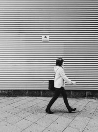 Full length of woman standing by railing