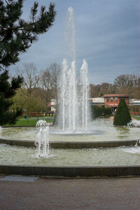 Water splashing in fountain against sky