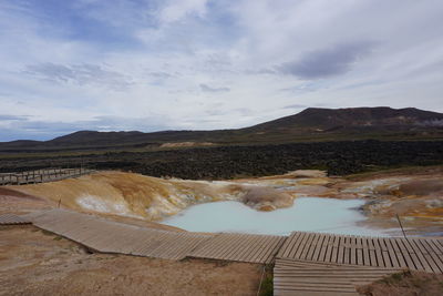 Scenic view of hot springs against sky
