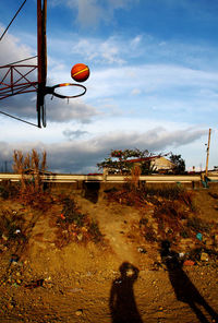 Silhouette of woman against cloudy sky