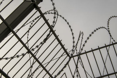 A metal fence with barbed wire as an insurmountable barrier