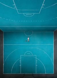 Digital composite image of man lying on basketball court