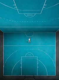Digital composite image of man lying on basketball court