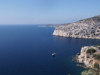 High angle view of sea and mountains against clear sky