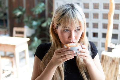 Portrait of woman drinking coffee