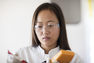 Scientist female with sample and tool in a lab