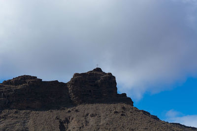 Low angle view of rock formations against sky