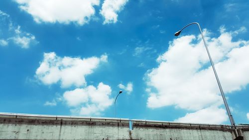 Low angle view of birds flying against sky