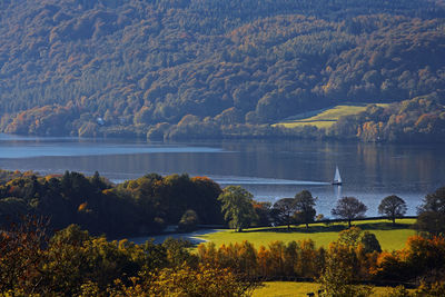 Sailing boat on a still lake in the british lake district