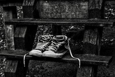 Close-up of shoes hanging on wood