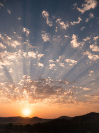 Scenic view of silhouette mountains against sky at sunset