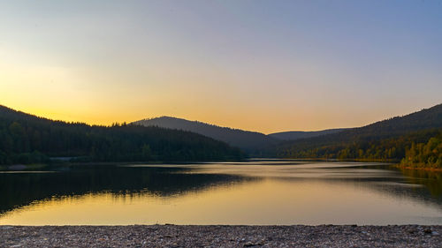 Scenic view of lake against sky during sunset