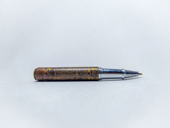 Close-up of pencil on table against white background