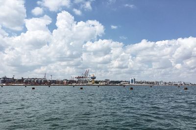 Panoramic view of sea and buildings against sky