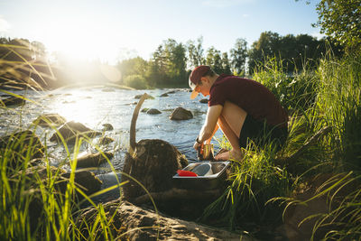 Young man at camping at lakeside