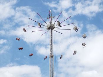 Low angle view of people on chain swing ride