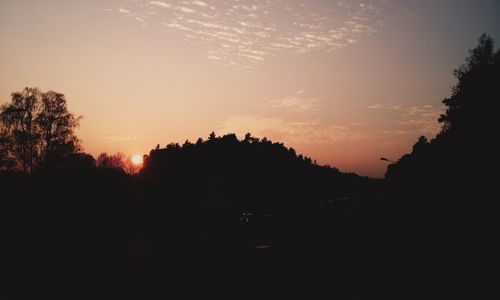 Silhouette trees against sky during sunset