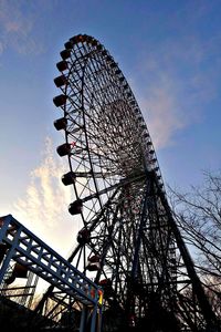 Low angle view of ferris wheel against sky