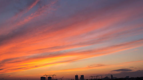Low angle view of silhouette buildings against sky during sunset