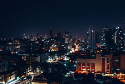 High angle view of illuminated buildings in city at night