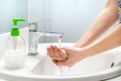 Midsection of woman with text in bathroom