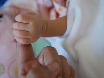 Cropped hand holding baby