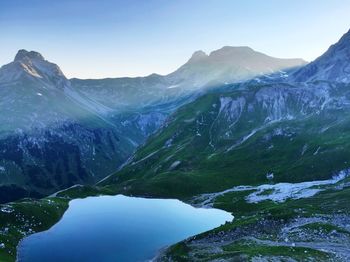 View of calm lake against mountain range