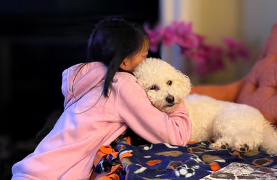 Rear view of woman with dog at home