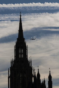 Low angle view of building against cloudy sky