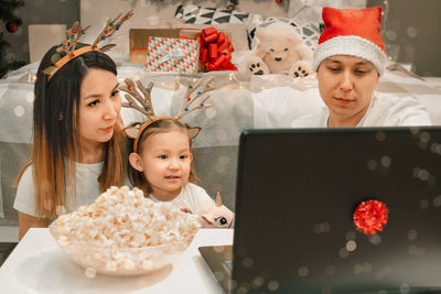 Cozy family christmas, happy fun and xmas holiday together at movie night or via video link