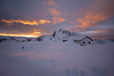 Scenic view of snow covered mountains against sky during sunset