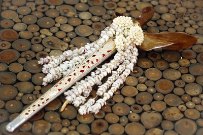 High angle view of garland and sword on table