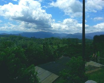 Scenic view of mountains against cloudy sky