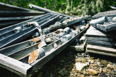 Close-up of wooden sewage pipes with stones