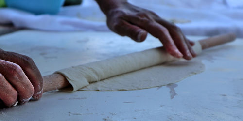 Close-up of person preparing food on table