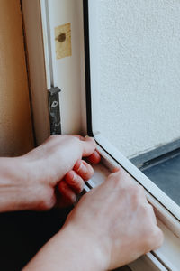 Cropped hand of woman using laptop