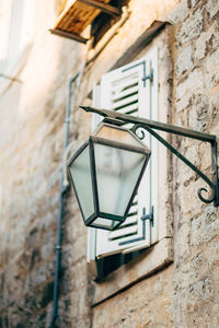 Low angle view of electric lamp on wall