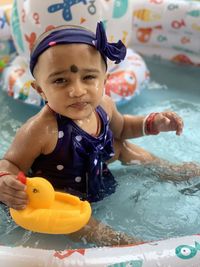 Portrait of cute girl in swimming pool