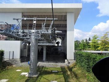 Metallic structure by building against sky