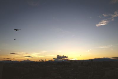 Silhouette of building against sky at sunset