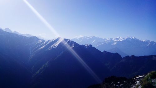 Scenic view of mountains against clear blue sky