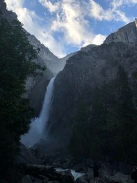 Scenic view of waterfall against sky